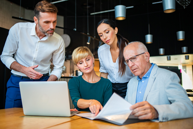 Coworkers reading about retirements plans
