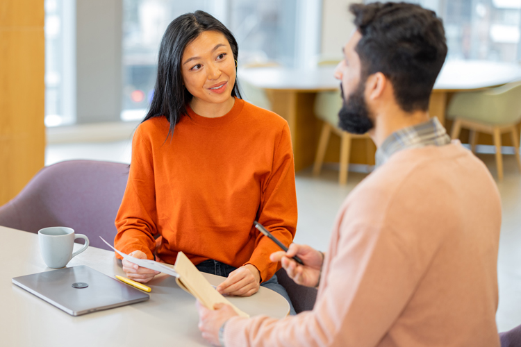 HR women explaining employee benefits to new hired person
