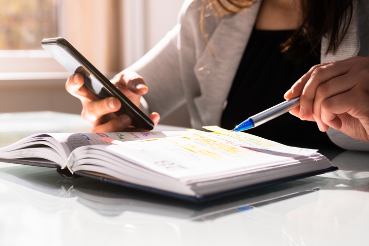 Person looking at directory on the phone closeup
