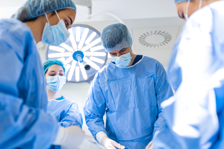 Surgeon with assistance in operating room