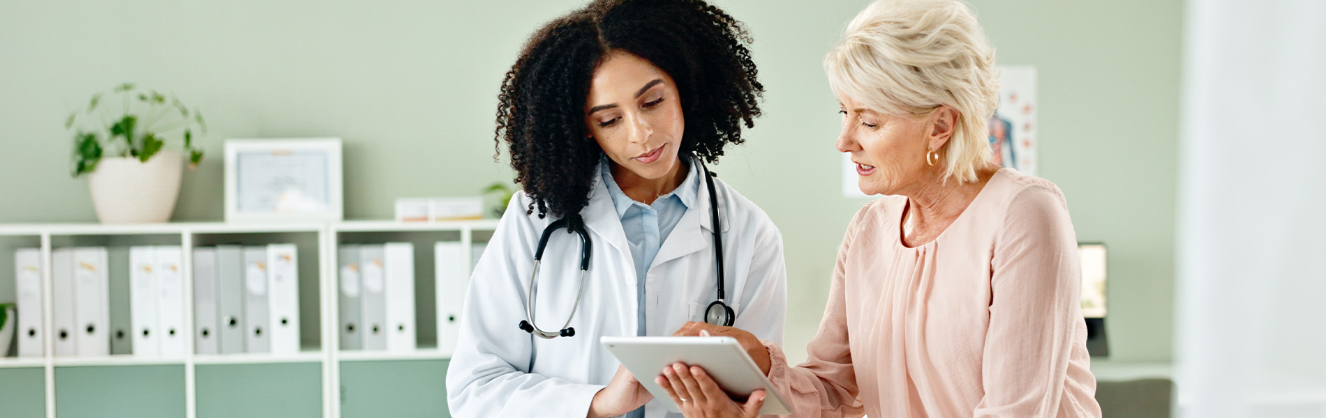 Doctor and patient looking at a digital tablet in the clinic