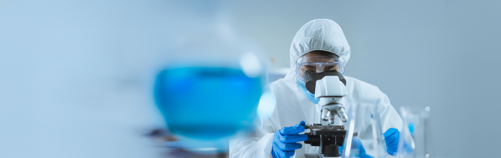 Scientist using microscope studying corona virus