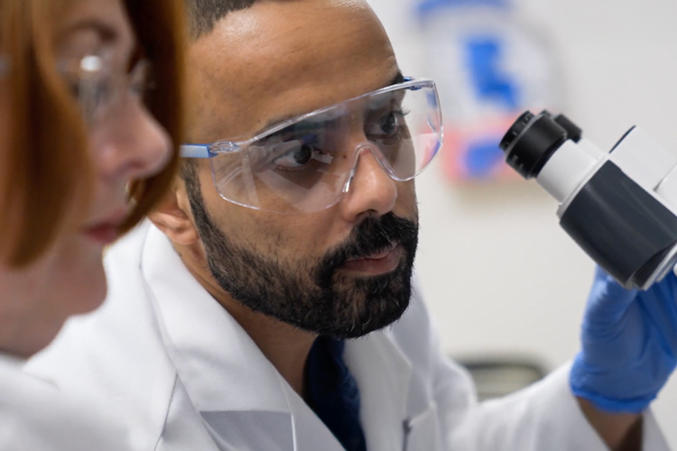 NSU researchers using microscope