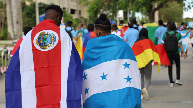 NSU students holding international flags outdoors