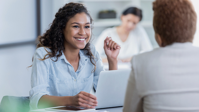 Two women speaking in an office