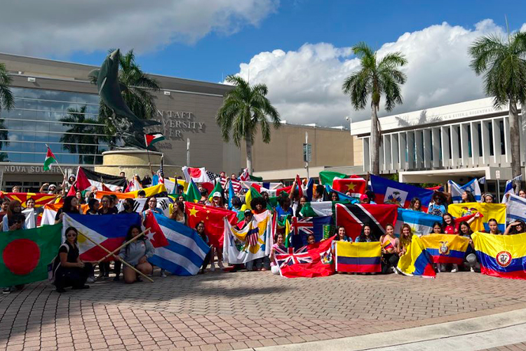 NSU students holding international flags outside of campus