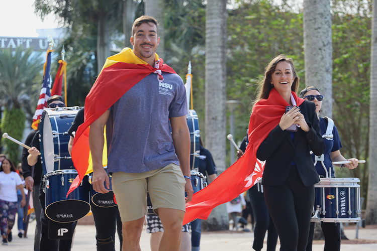 NSU students walking with flags during a parade