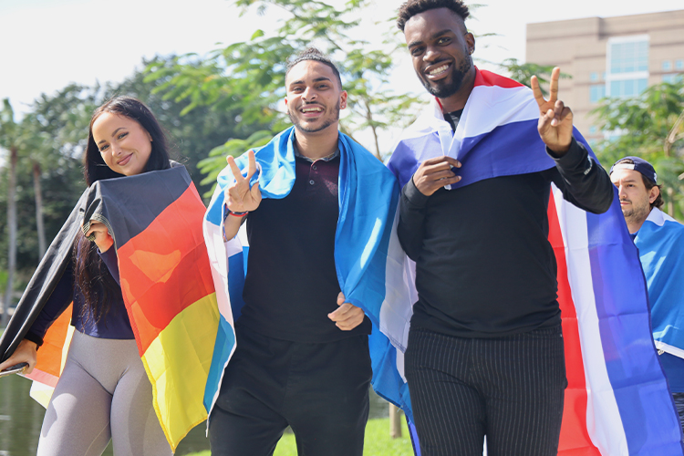 Students holding international flags outdoors