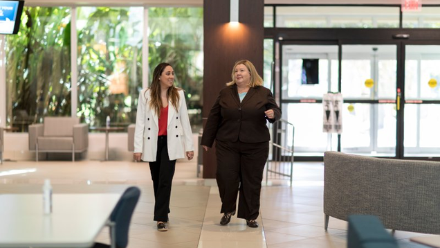 two NSU students walking through campus bulding lobby