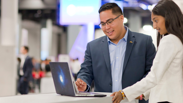 Two professionals lookoing at alumni resources