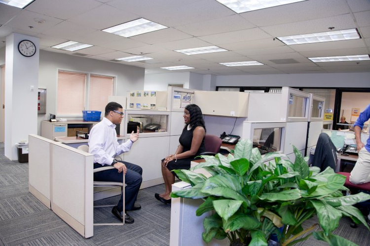 NSU student talking at office cubicle with career counselor