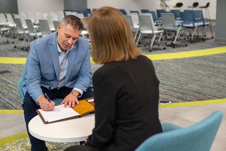 Man and Woman Sitting Down During Interview
