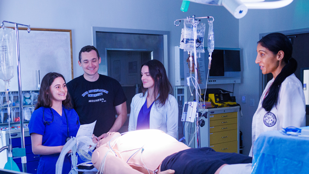 Faculty teaching students at simmulation lab