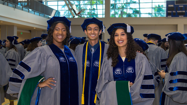 MD graduates at commencement with cap and gown