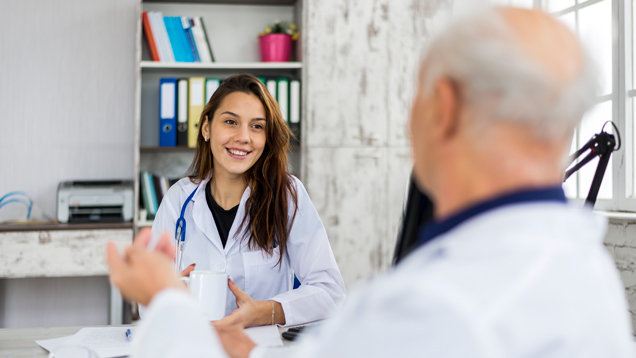 Medical student talking with professor.