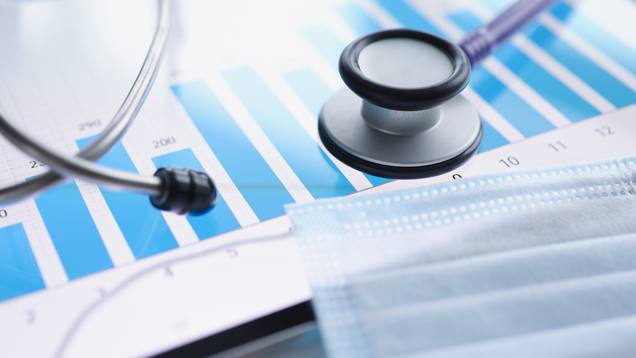 Stethoscope and mask with population health data chart