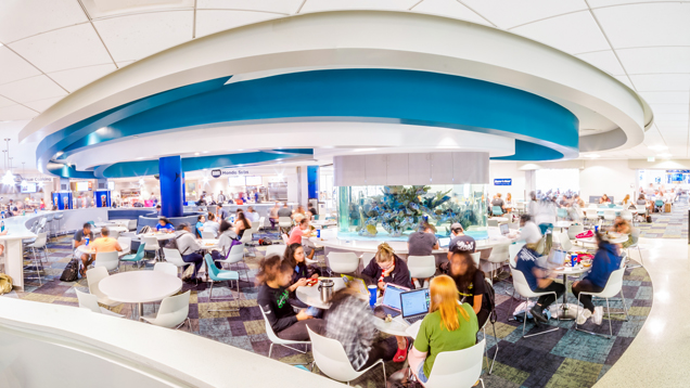 Shark dining at campus area full of student using the space