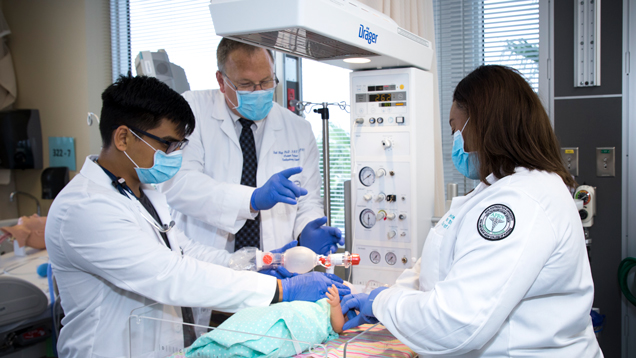 Students learning respiratory therapy with baby scenario