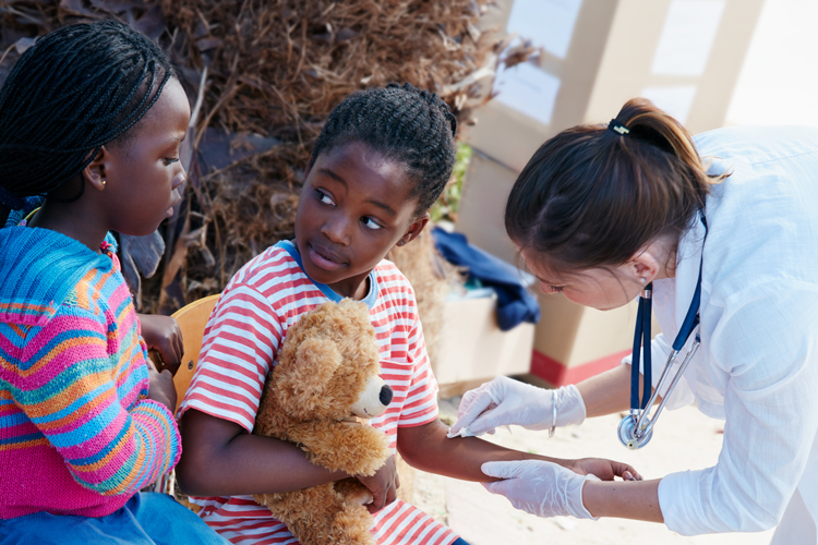 Medical student providing care to children.