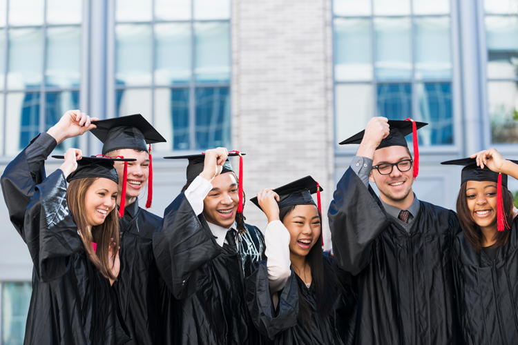Students touching graduation cap