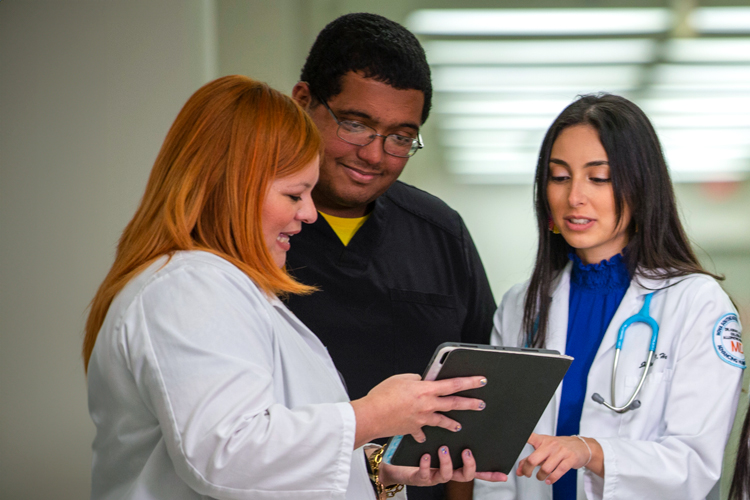 Medicak students getting support looking at digital tablet