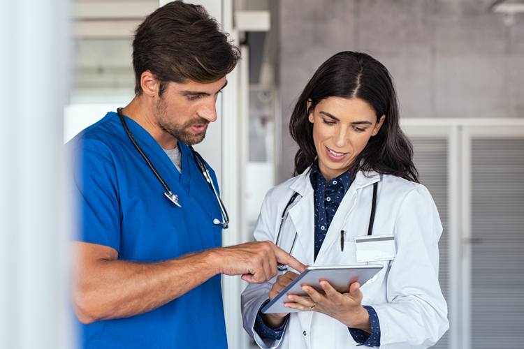 Physician assistant speaking to doctor