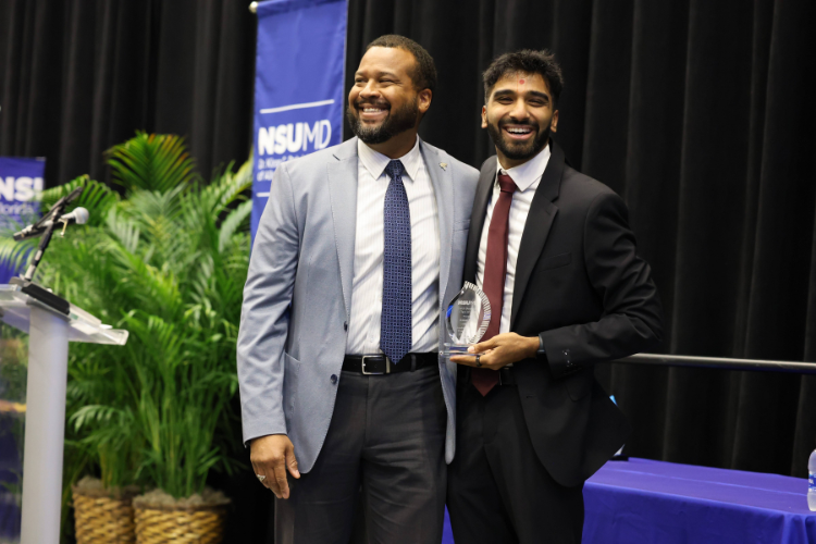 Professor presenting an award to a student