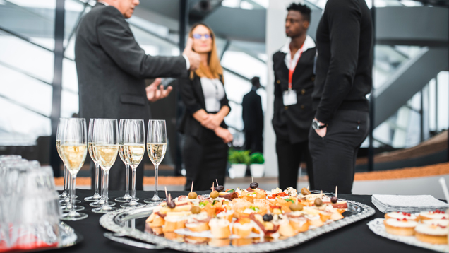 Catering at event on table closeup with people on background
