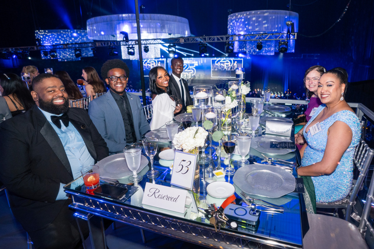 People smiling on reserved table at arena event