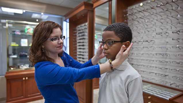 Kid at NSU eye care trying glasses