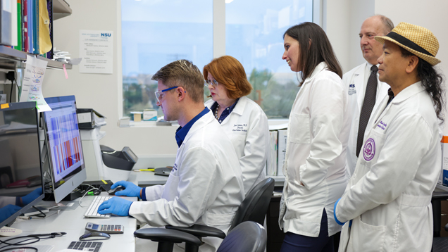 NSU researchers looking at computer screen