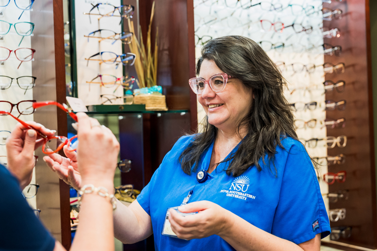 At NSU optometry office professional attending patient