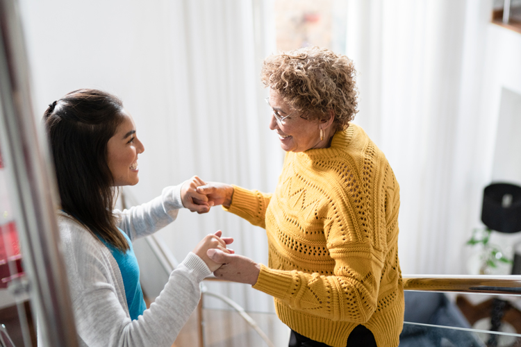 Senior person with parkinsons getting help