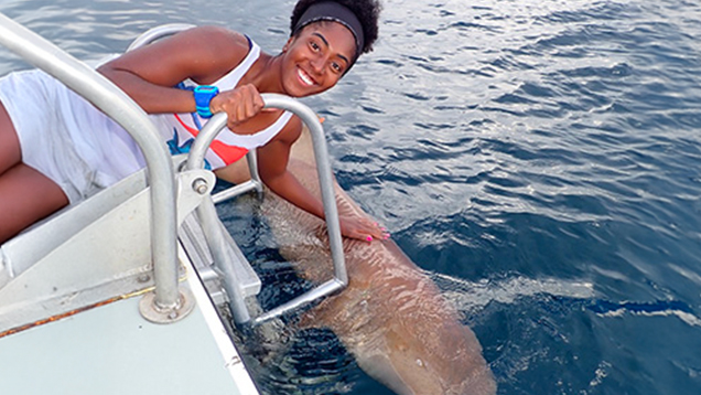 Carlee Jackson next to a shark in the water