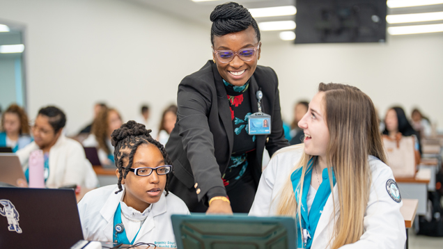 faculty helping nursing students