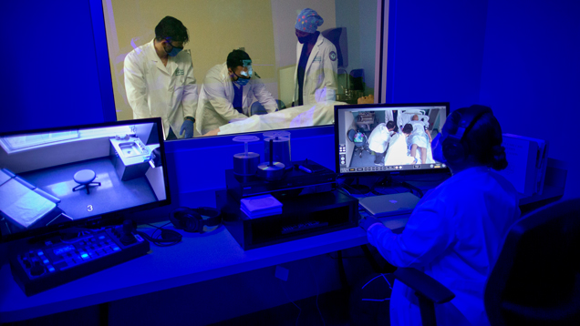 Nursing students doing experimental learning dark blue room