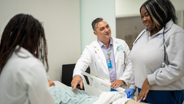 Professor teacing nursing students at the simulation lab