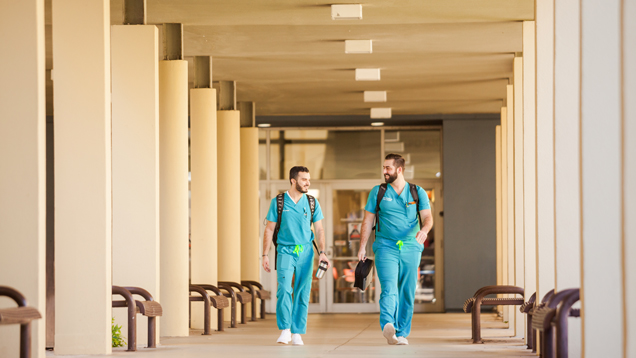 Students in nursing school scrubs uniform walking around campus
