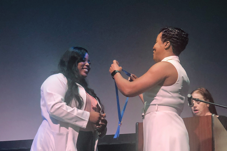 Future NSU nurse on pinning ceremony at the stage