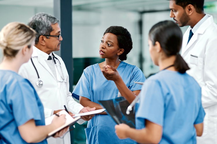 Group of nurses and doctor speaking