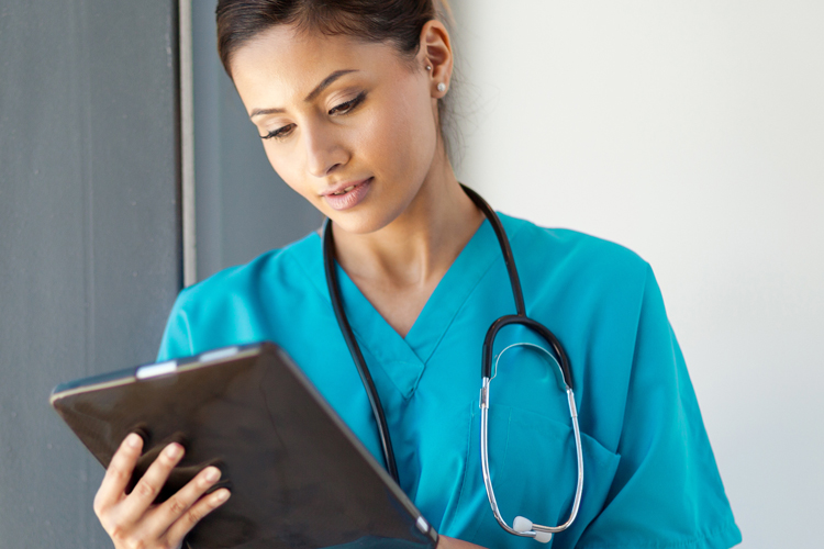 Nurse lady looking to digital tablet for tuitions