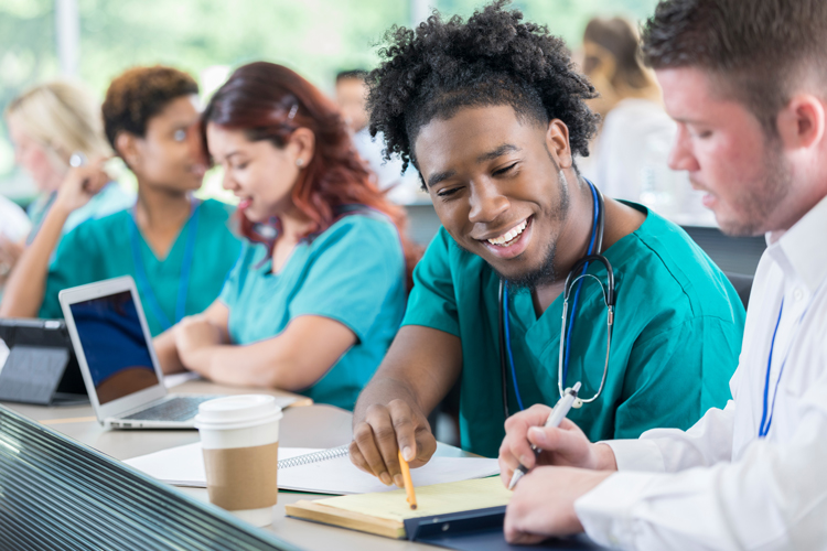 Nursing school students discuss something or working on a project together