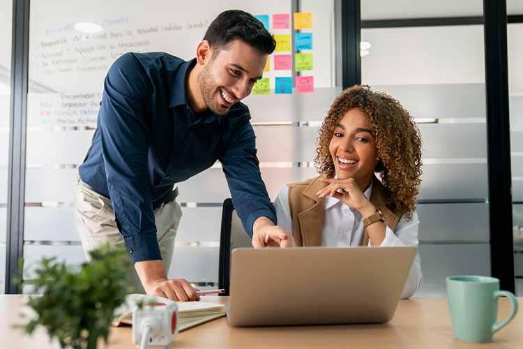 Man and woman using a laptop at the office
