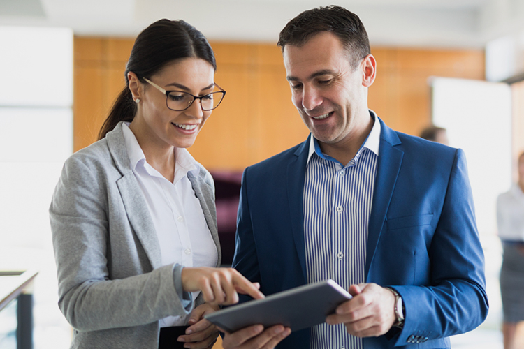 Two business people using a digital tablet