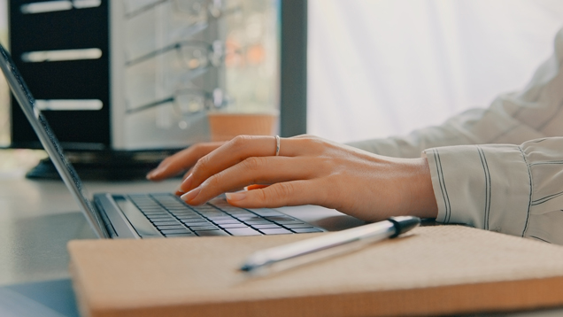 Person submitting continuing education documentation online using laptop closeup
