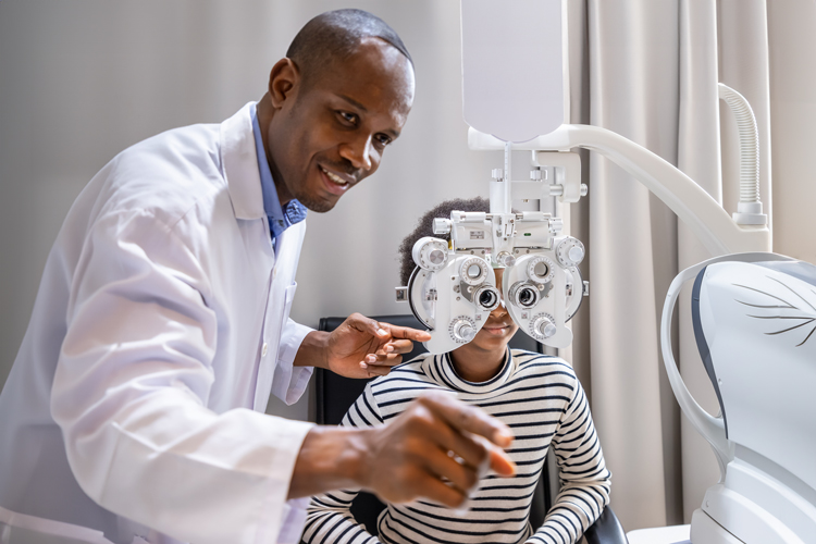 Optometrist doing eye exam to child.