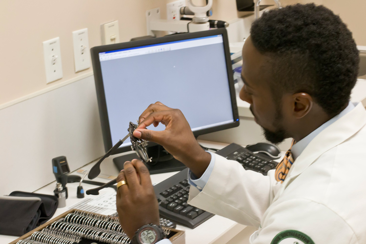 Student working with eye care tools
