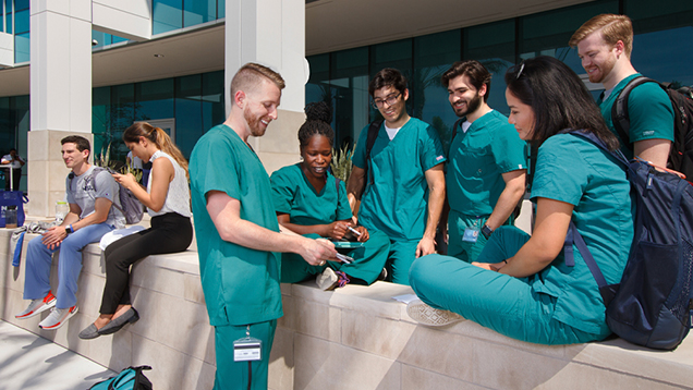 Group of NSU students talking outside of campus