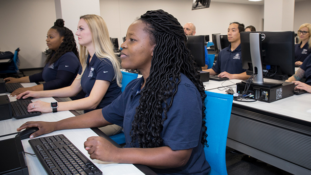 Group of physical therapists using their computers in class