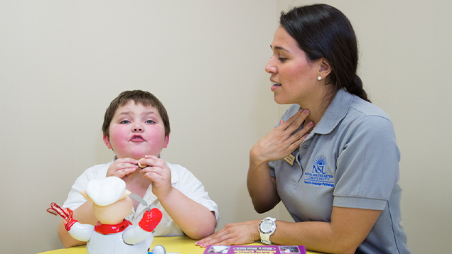 Speech therapist helping a child to talk